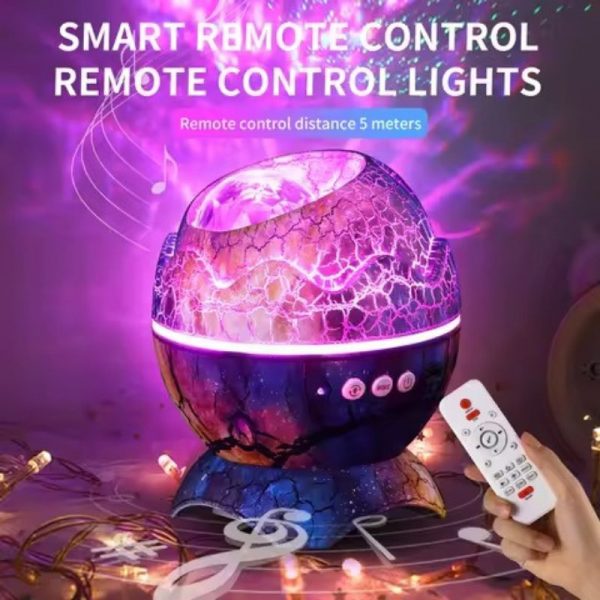 Dinosaur Egg Galaxy Projector Lamp with stars and nebula projection, also showing the included remote controller and USB cable
